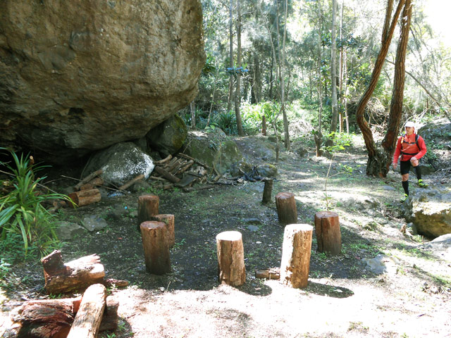 Abri sous un gros rocher avec feu et emplacements pour le repas